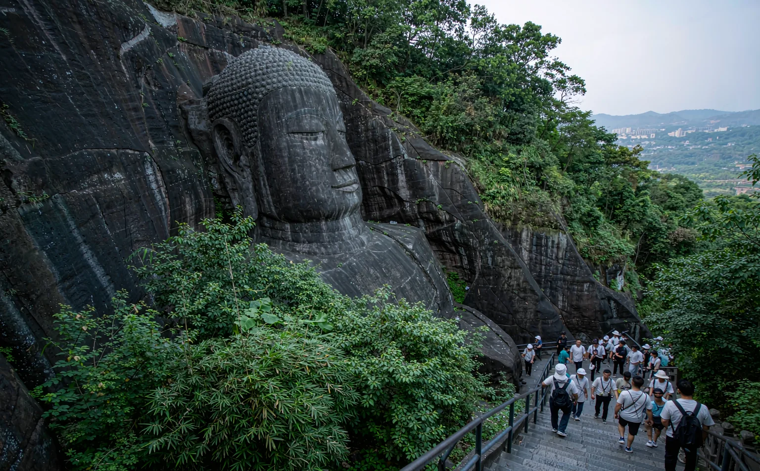 Visitors descending the cliff path beside the Leshan Giant Buddha