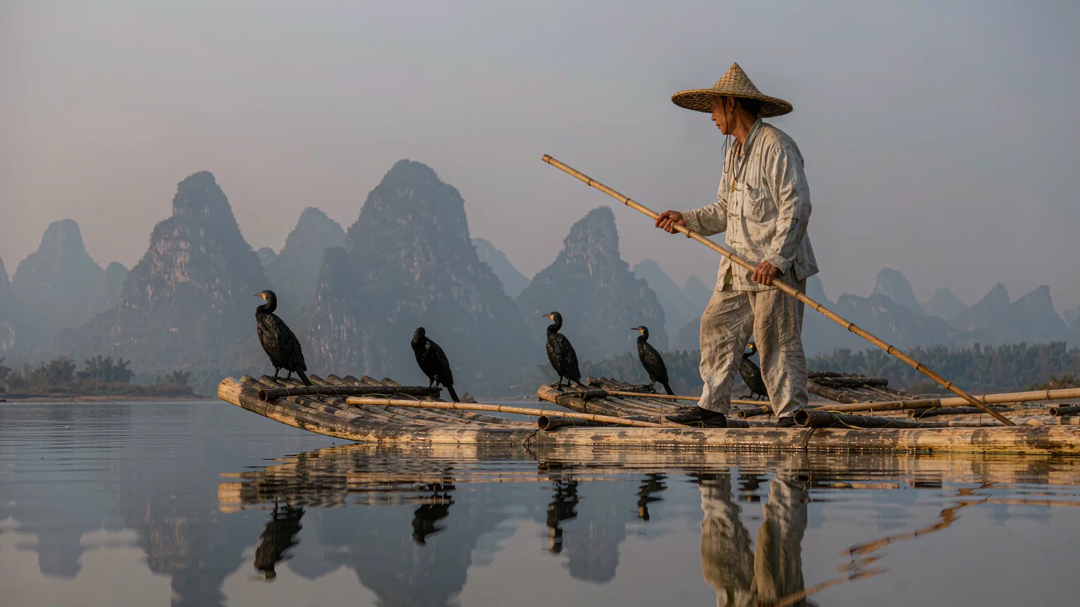 Close-up of cormorant fisherman on bamboo raft on Li River