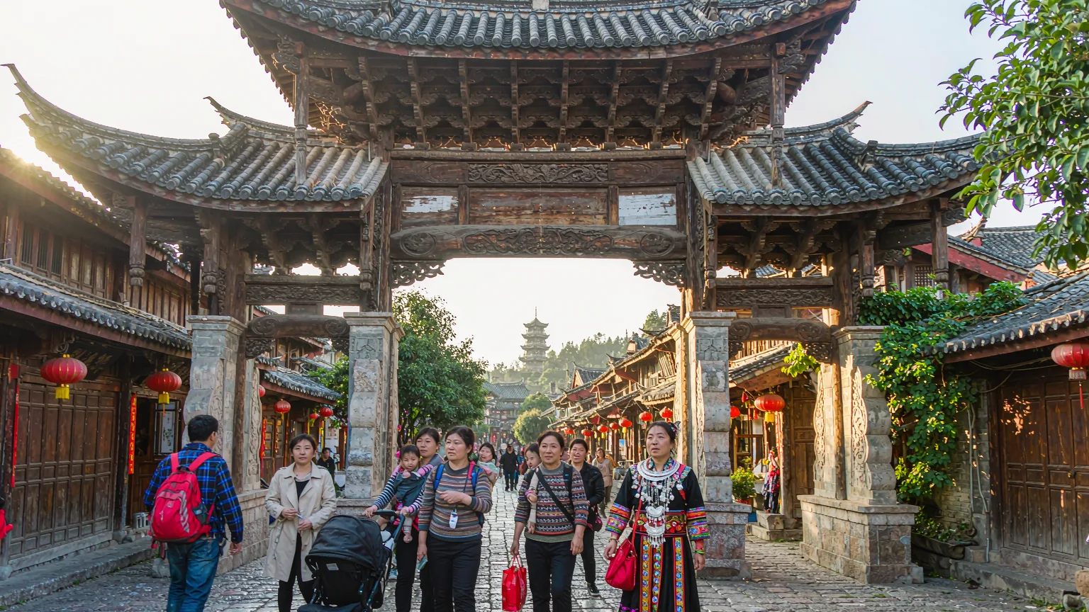 Tourists entering Lijiang Old Town through traditional wooden gate