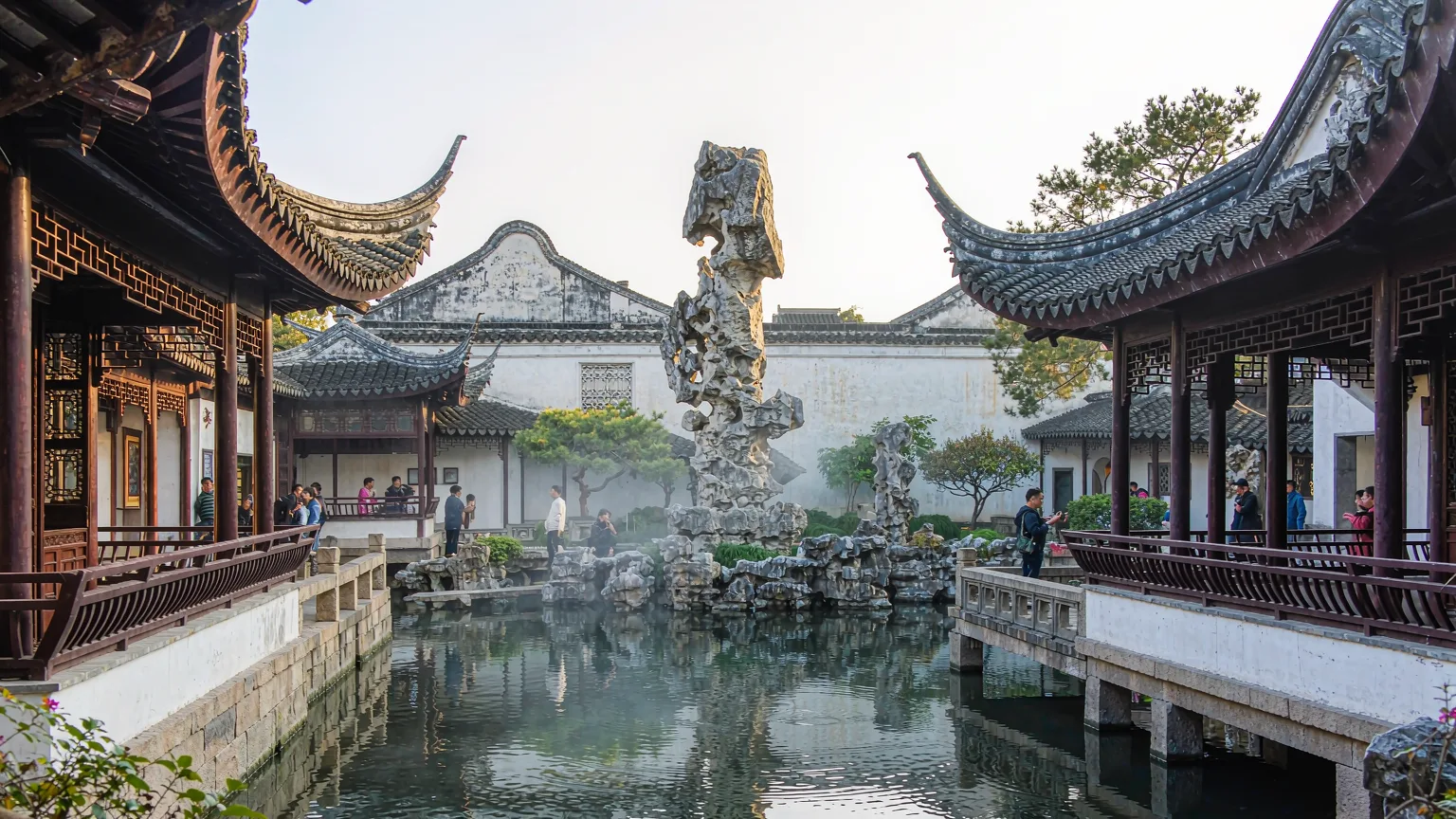 Cloud-Capped Peak rockery towering over Lingering Garden's central pond with pavilions