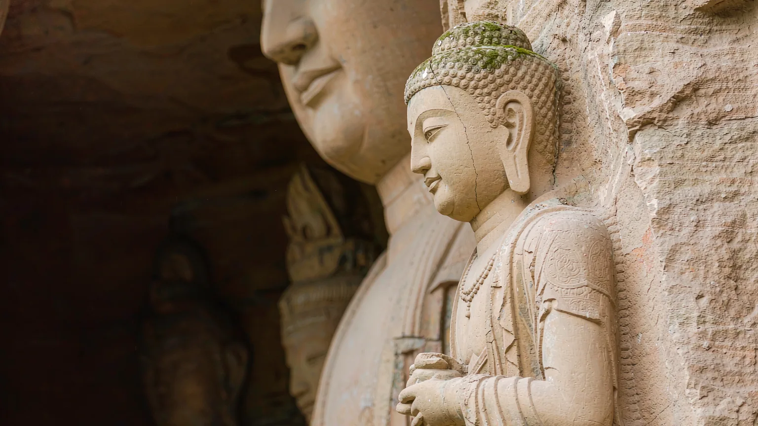 Close-up of weathered Buddhist statue carving at Longmen Grottoes