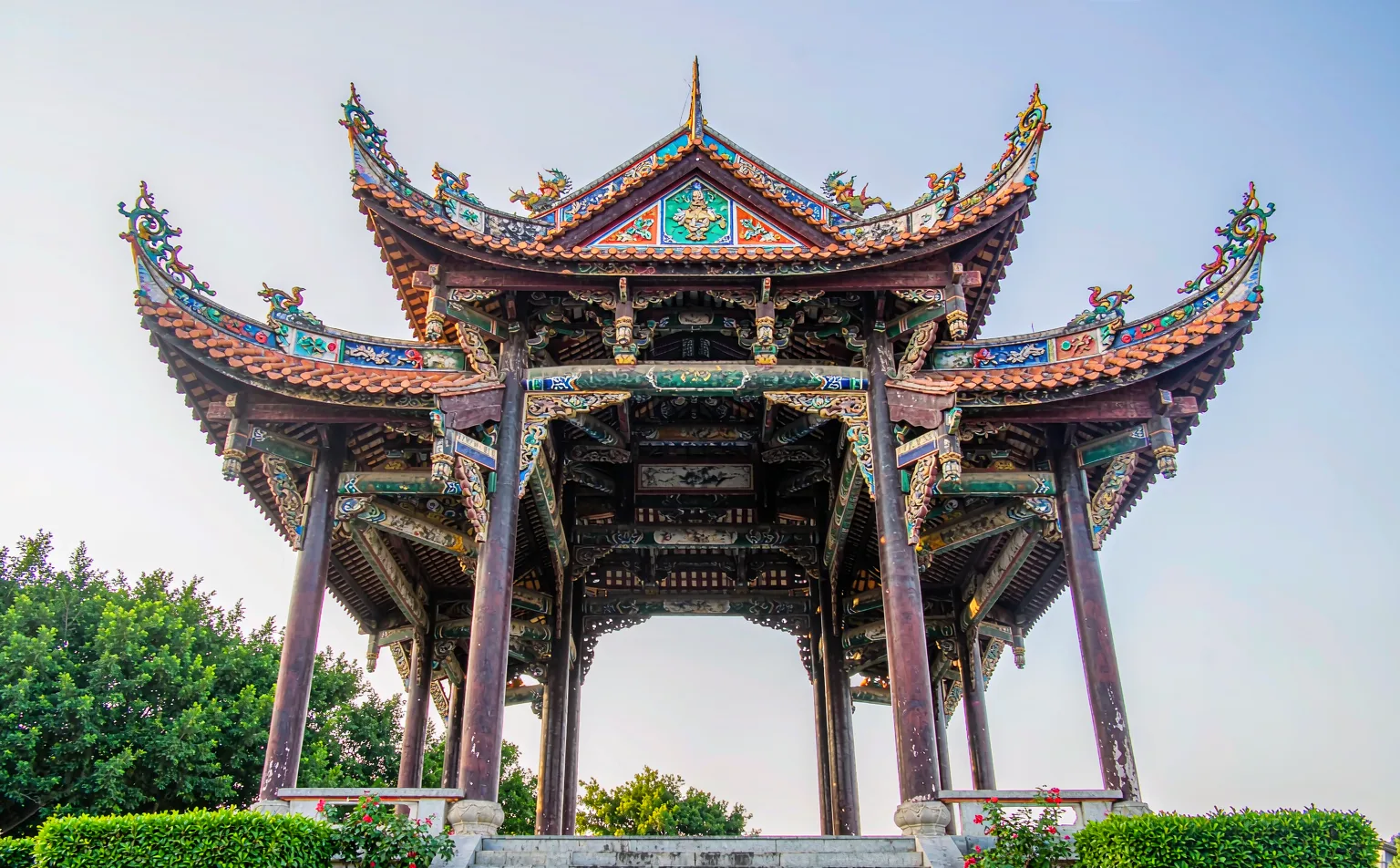 Red columns and carved beams of the Guangdong Guild Hall in Luodai
