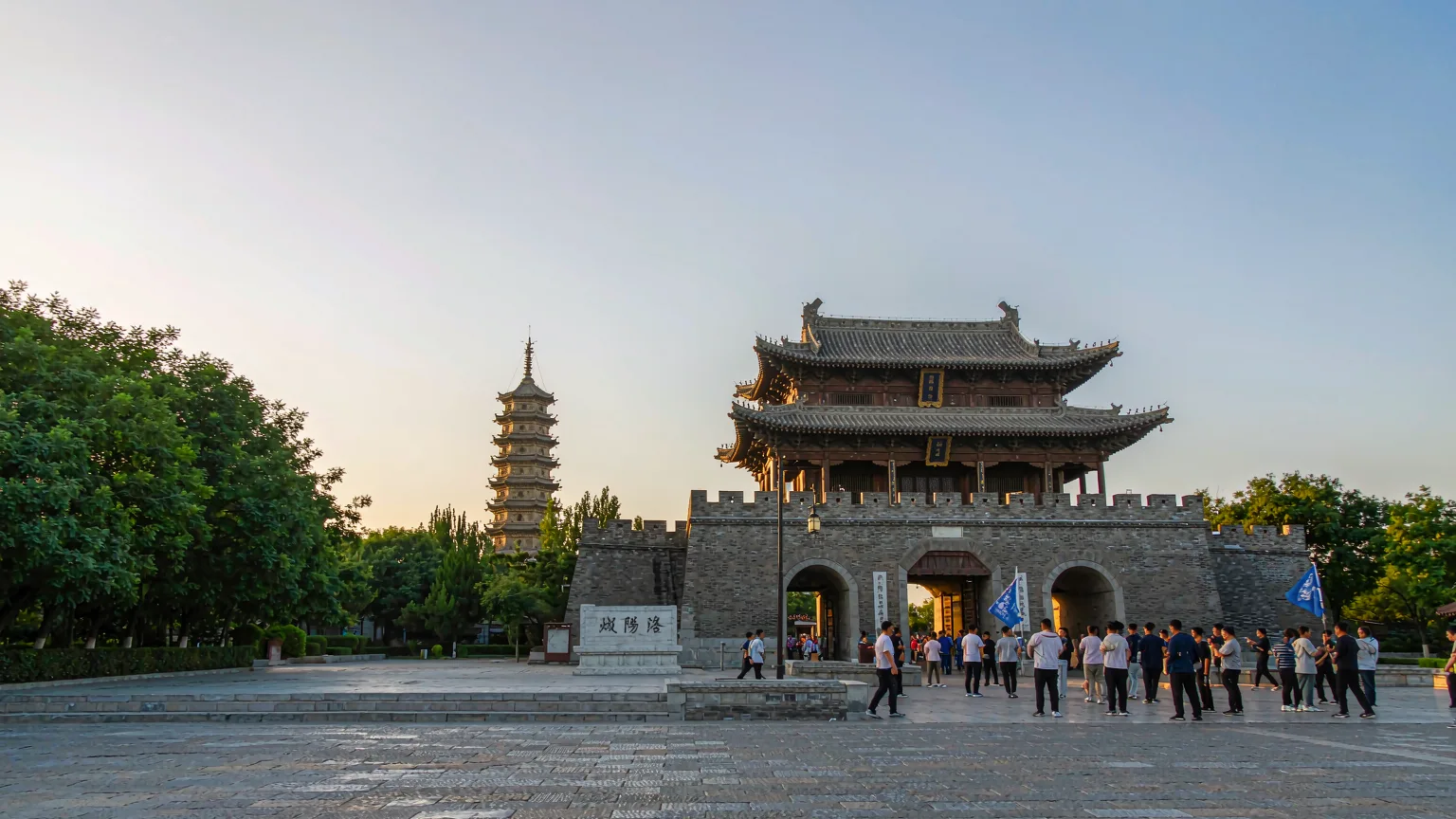 Tourists entering Luoyi Ancient City gate with Wenfeng Pagoda in background