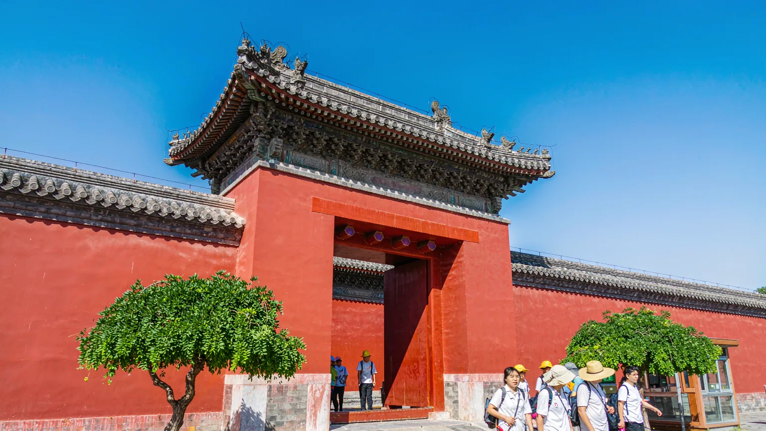 Tour guide leading group through entrance gate of Ming Dynasty Tombs