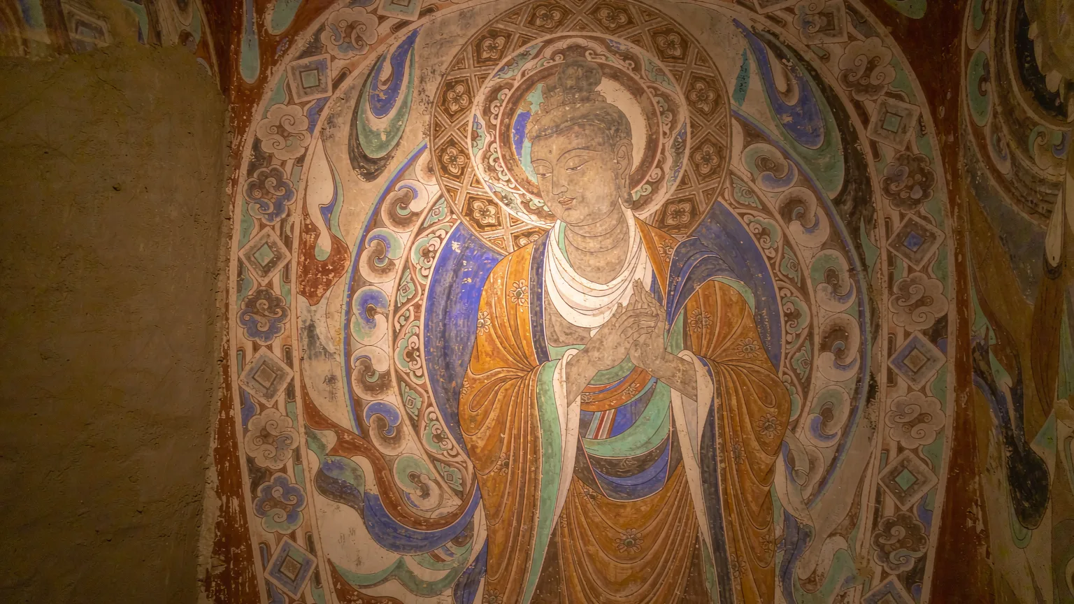 Close-up of ancient Buddhist mural inside Mogao Cave