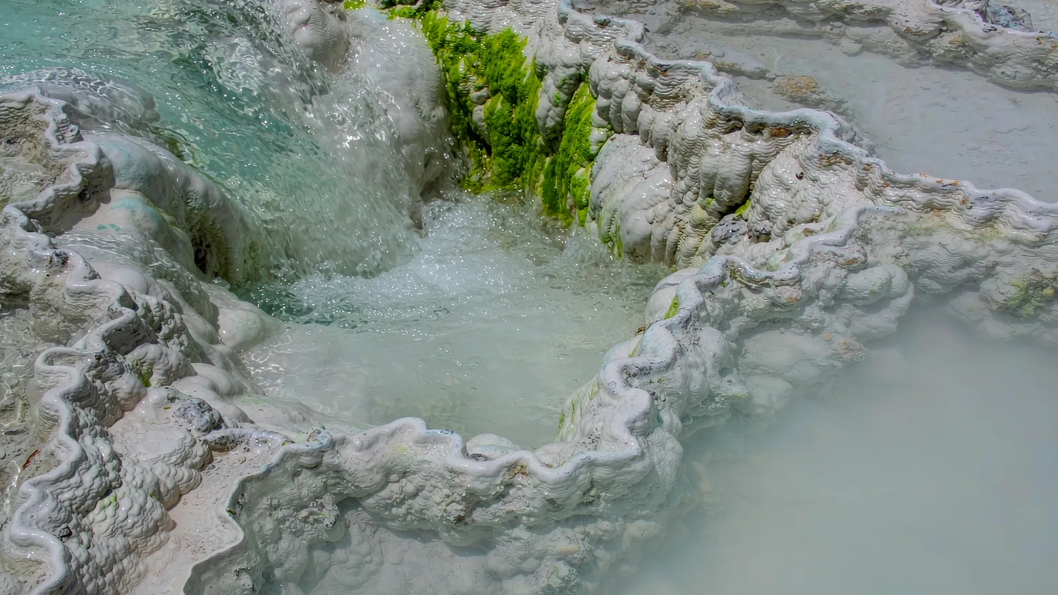Close-up of travertine deposits and trickling water in Munigou Valley