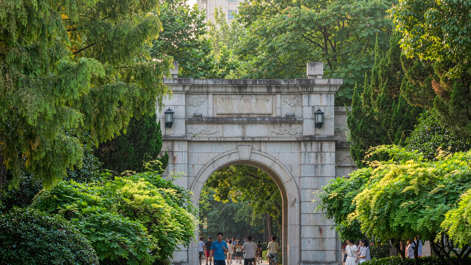 Main entrance of Nanhu Park with visitors and bicycles
