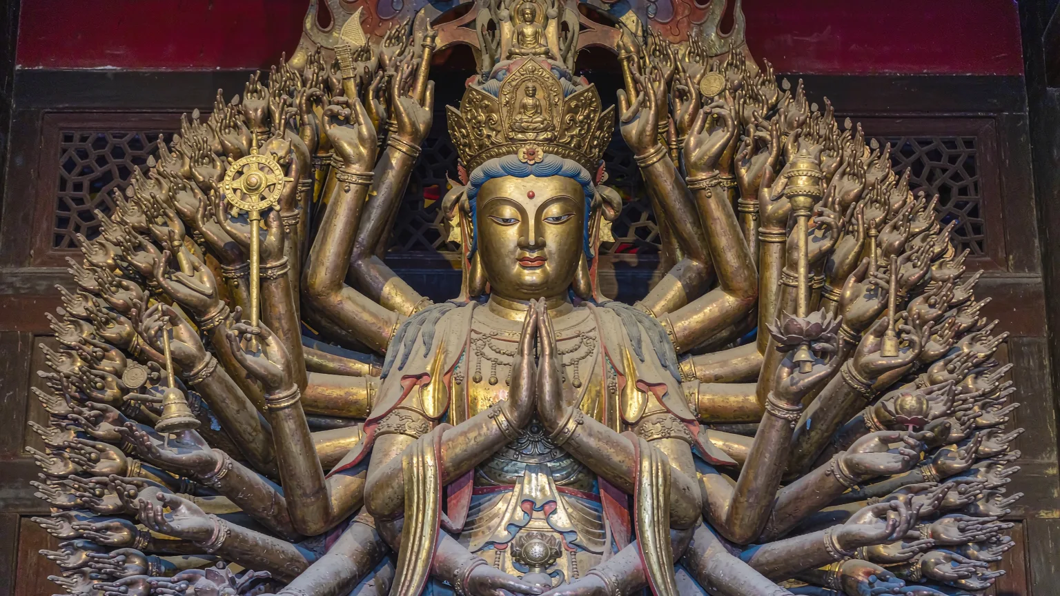 Golden thousand-armed Guanyin statue inside Nanputuo Temple