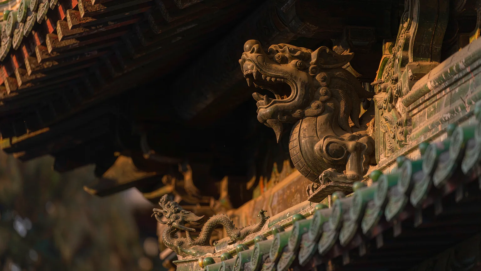 Close-up of bronze dragon motifs and green tiles on museum roof