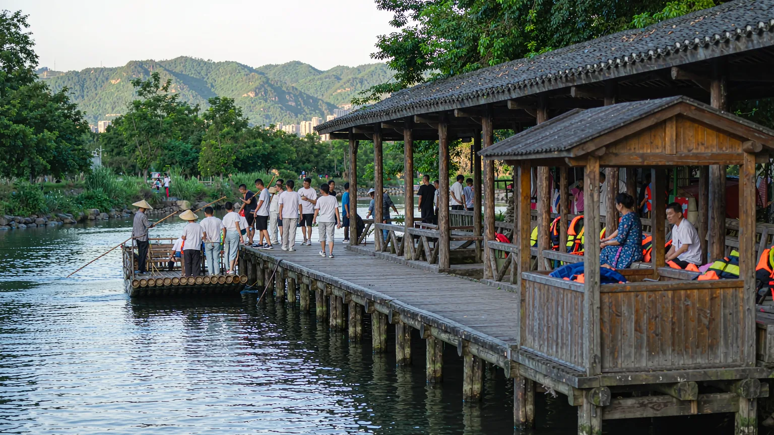 Tourists boarding bamboo rafts at Nine-Bend Stream pier in Wuyishan