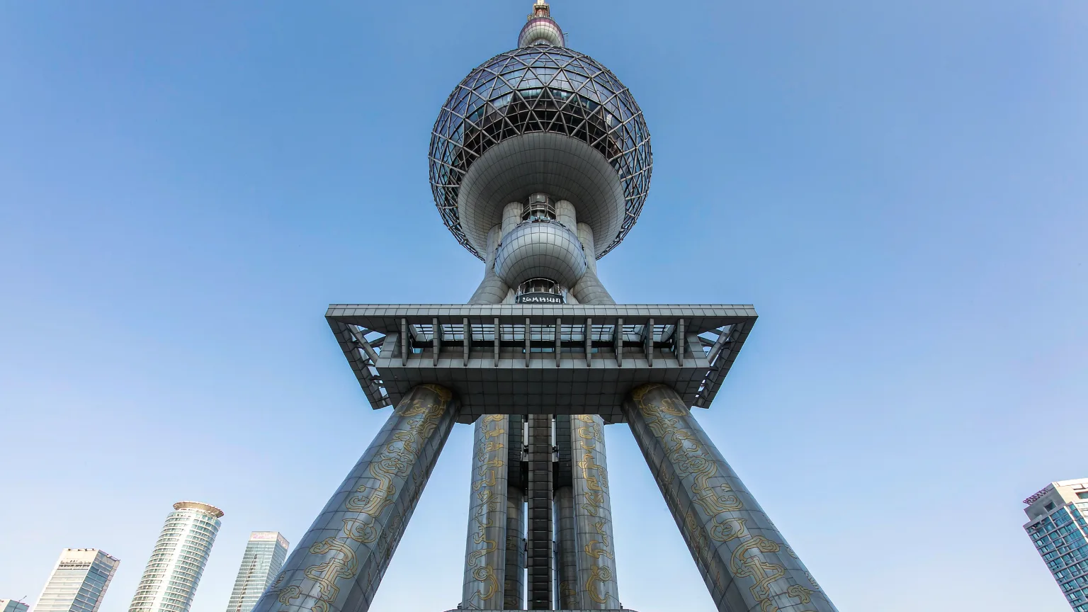 Low-angle view of Oriental Pearl Tower's spheres and columns against Pudong skyline