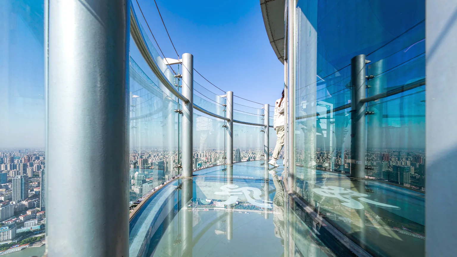Transparent glass floor of Oriental Pearl Tower's observation deck overlooking Huangpu River