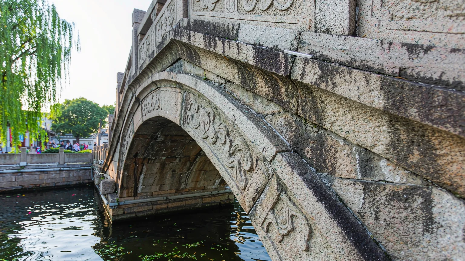 Close-up of traditional stone bridge arch over Pingjiang Canal in Suzhou