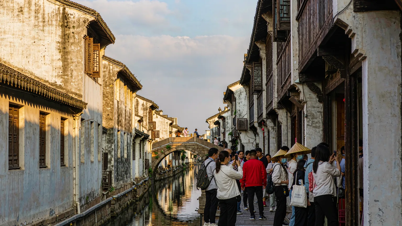Visitors walking along stone-paved Pingjiang Road in Suzhou