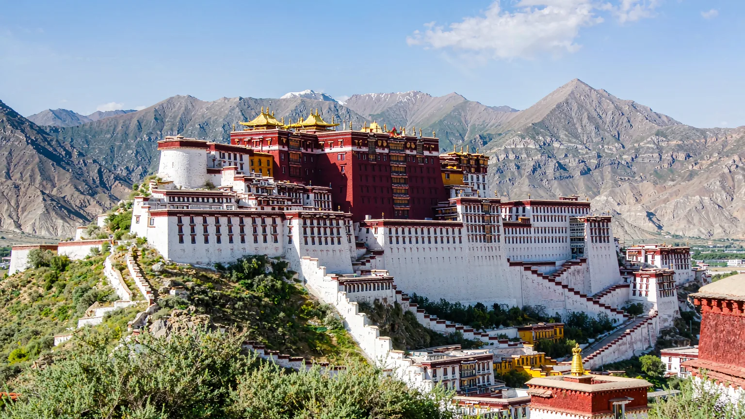 Potala Palace's white and red palaces with Himalayan backdrop