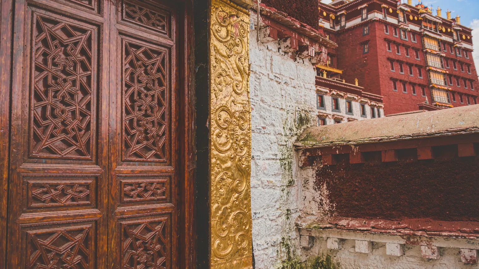 Close-up of intricate carvings on Potala Palace's Red Palace door