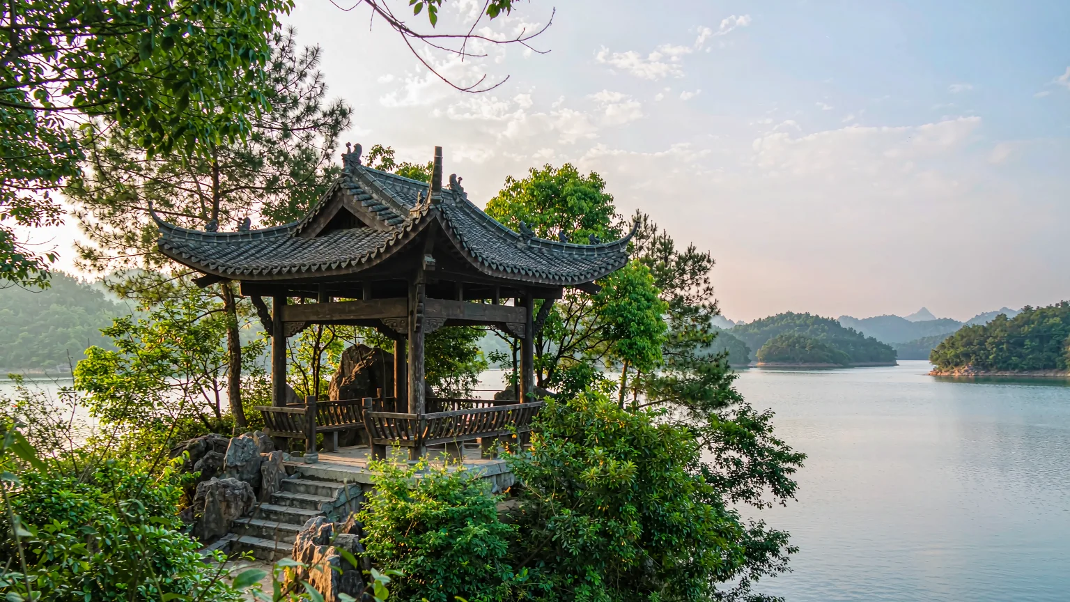 Traditional pavilion on a Qiandao Lake island with trees and water