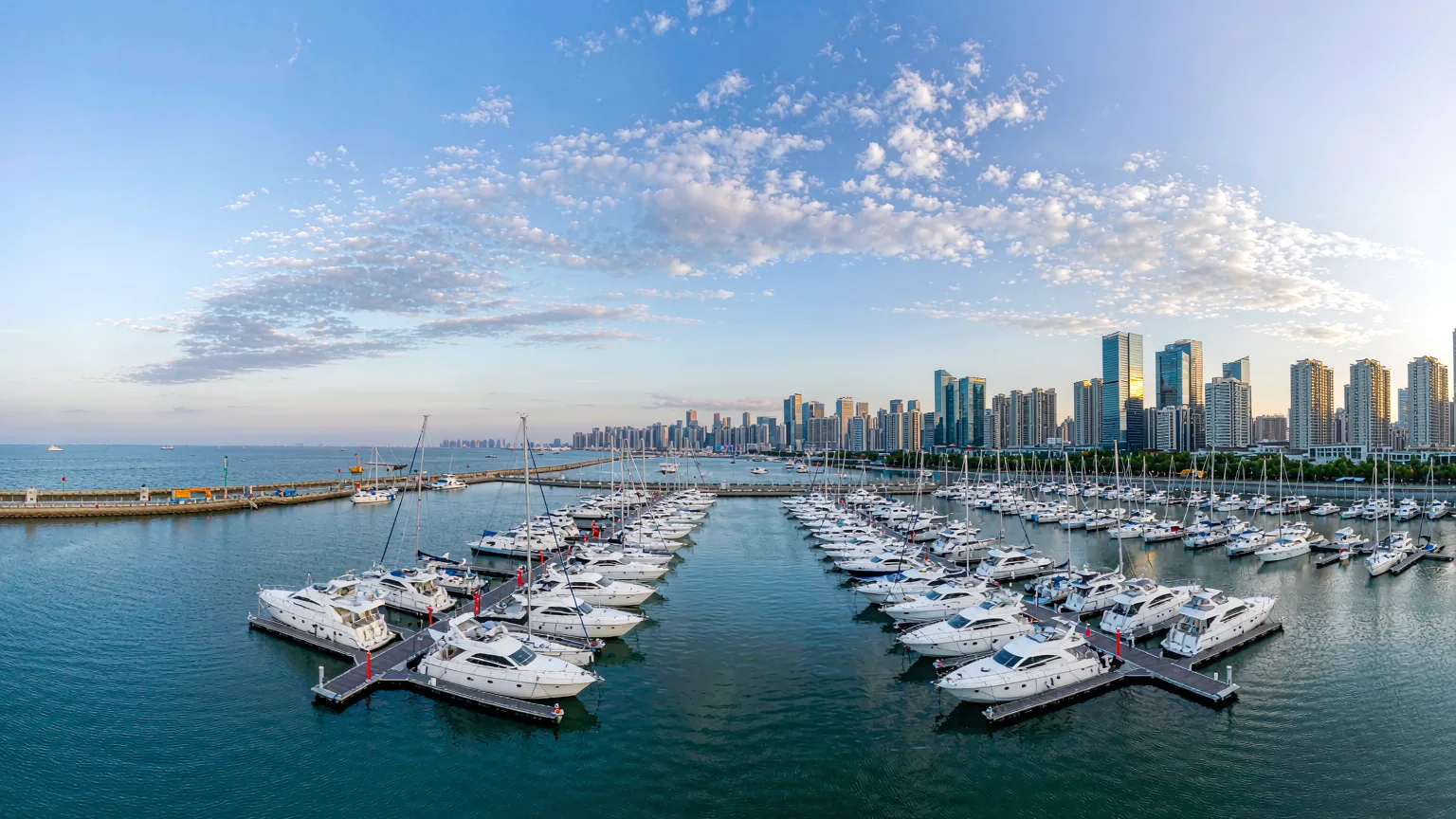 Panoramic view of Qingdao Olympic Sailing Center marina with yachts and skyline