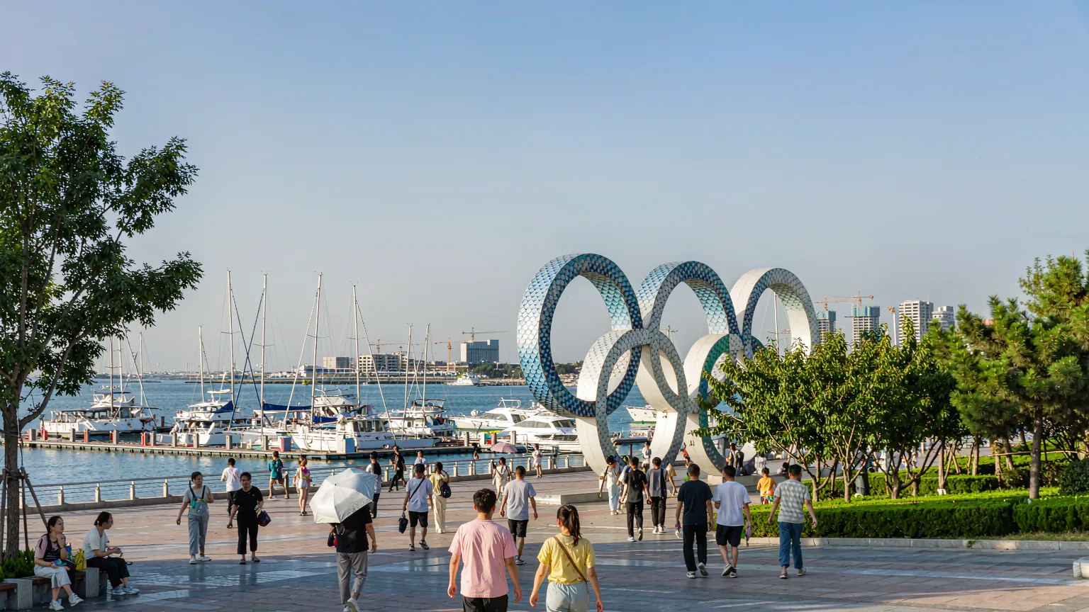 Tourists walking along promenade at Qingdao Olympic Sailing Center entrance