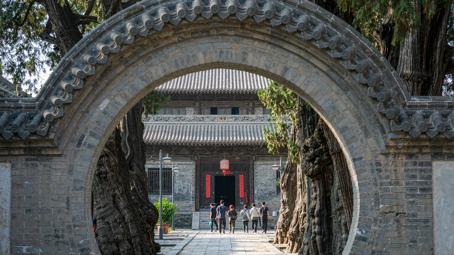 Tourists entering Qingjing Mosque through its historic stone gate in Quanzhou