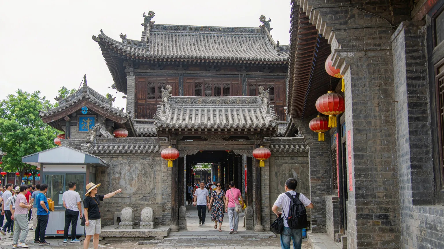 Tour group entering Rishengchang Exchange Shop from Pingyao's ancient street
