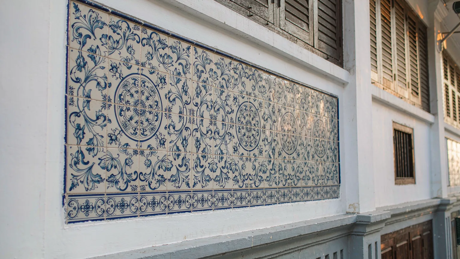 Close-up of blue and white Portuguese azulejo tiles on a shophouse in Rua do Cunha
