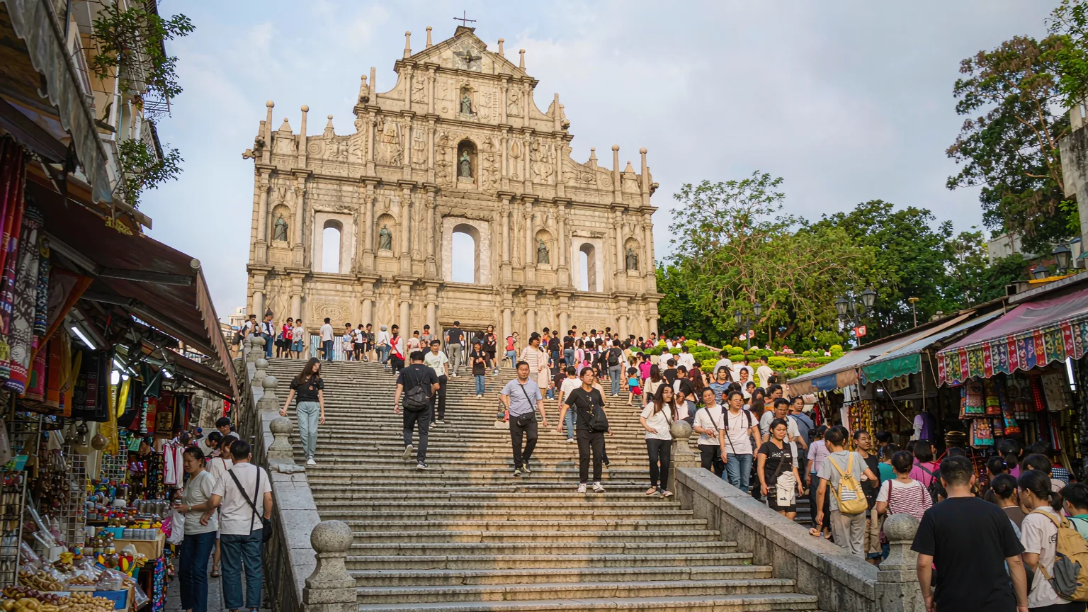 Tourists climbing the grand staircase to Ruins of St. Paul's