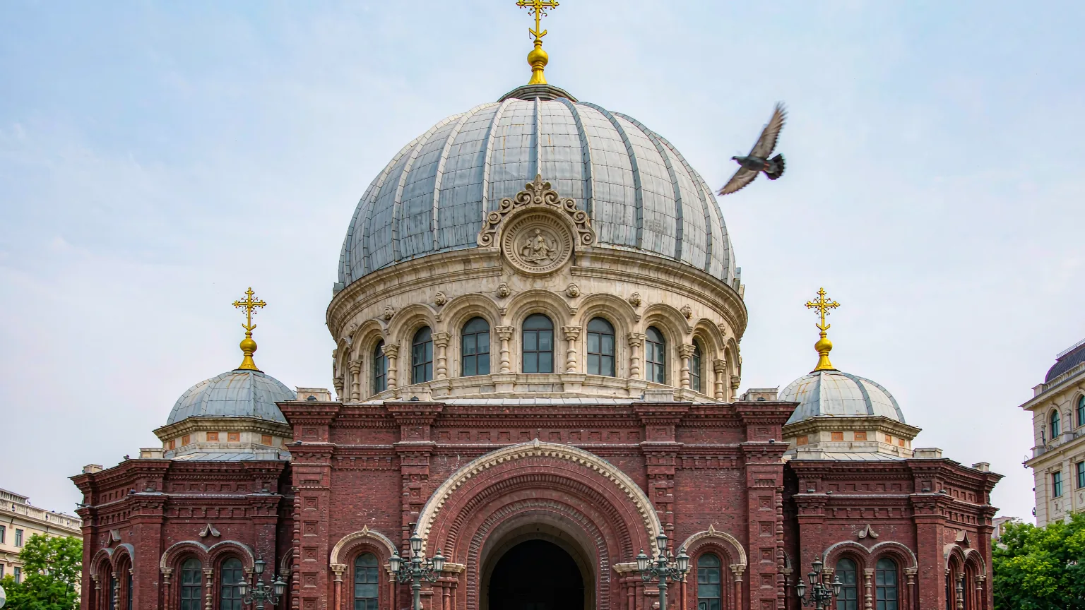 Front facade of Saint Sophia Cathedral with red brick and onion domes