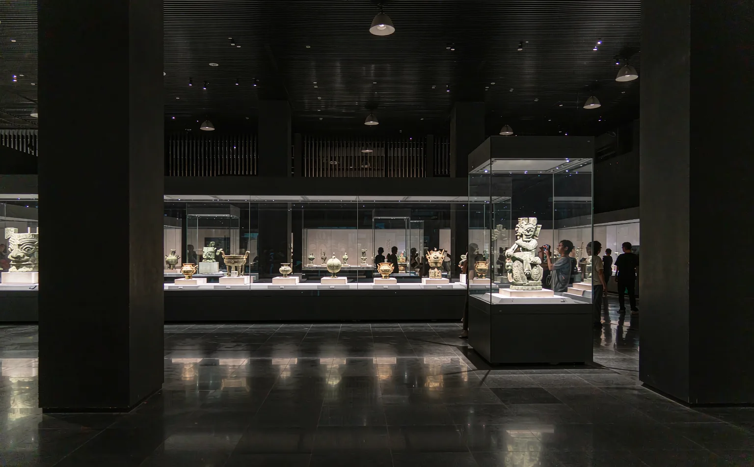 Bronze artifacts displayed under dramatic lighting in Sanxingdui Museum