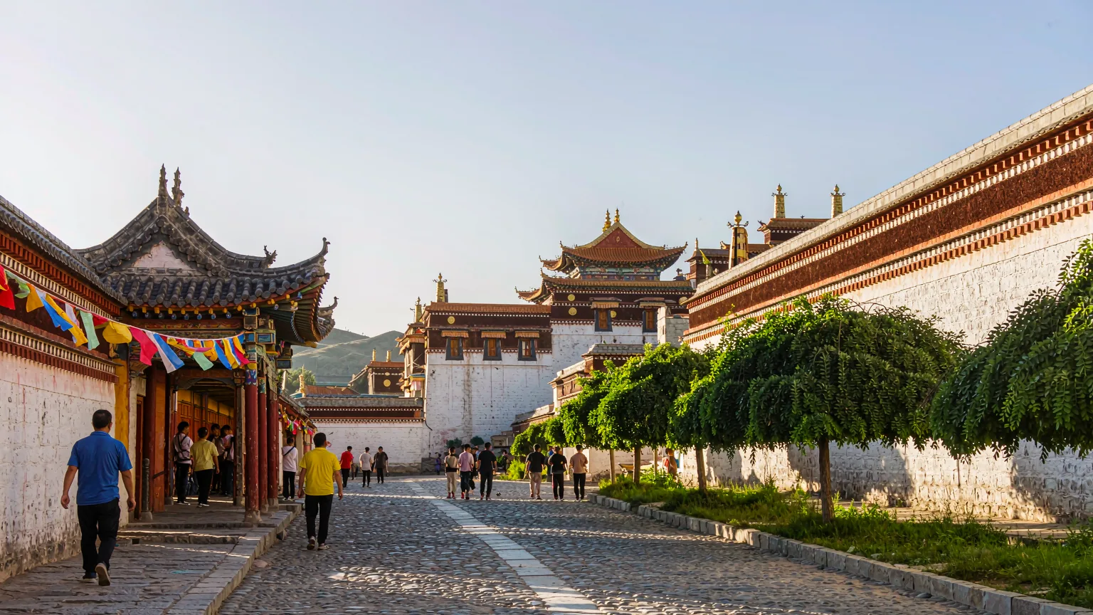 Pilgrims and visitors walking through the entrance gate of Sera Monastery