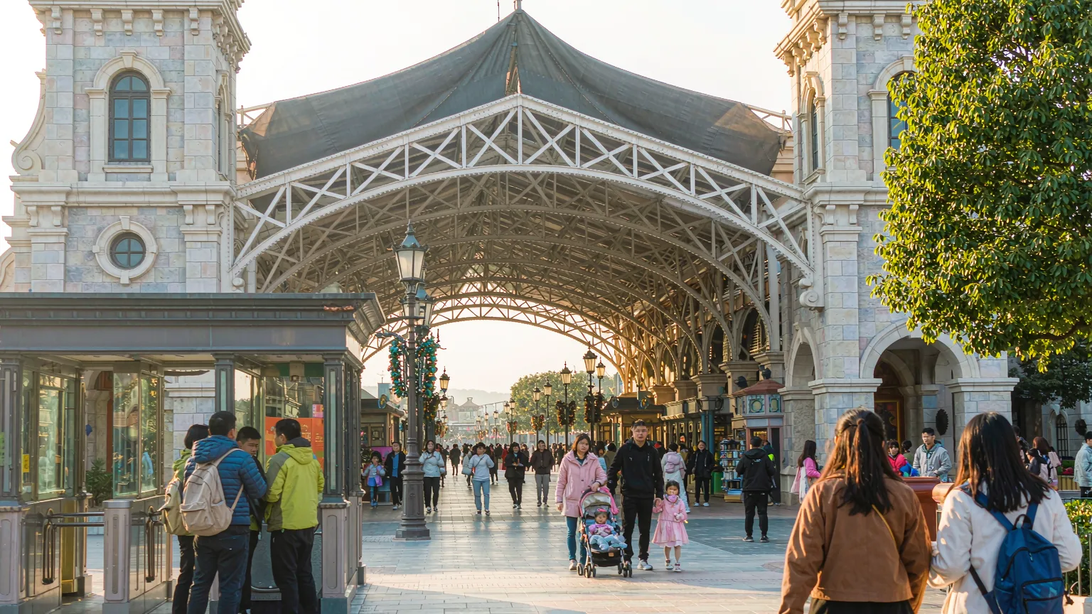 Visitors entering Shanghai Disney Resort through main gate on sunny morning