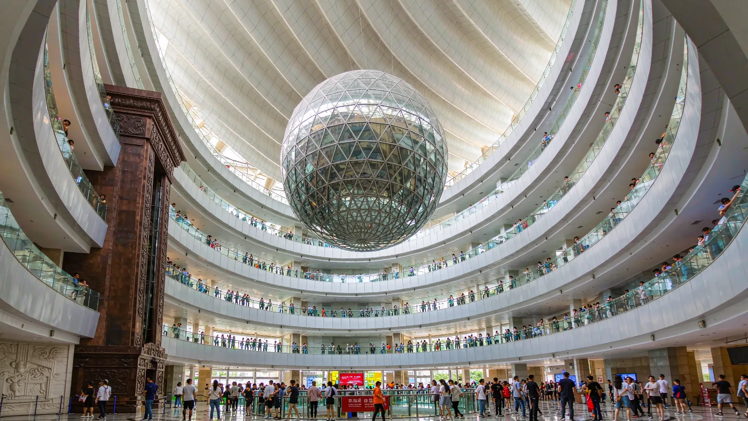 Sunlit atrium of Shanghai Science and Technology Museum with glass sphere