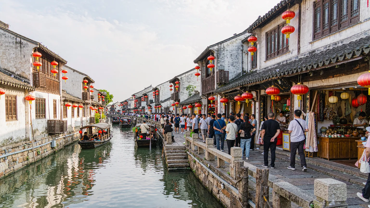 Bustling historic Shantang Street lane with traditional houses and canal