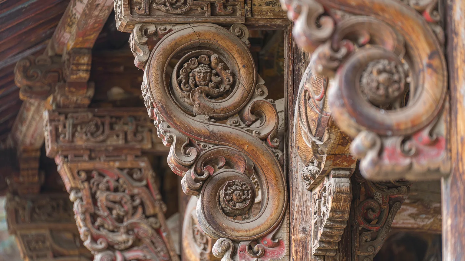 Close-up of intricate wood carvings on Ming-dynasty theatre stage in Shaxi