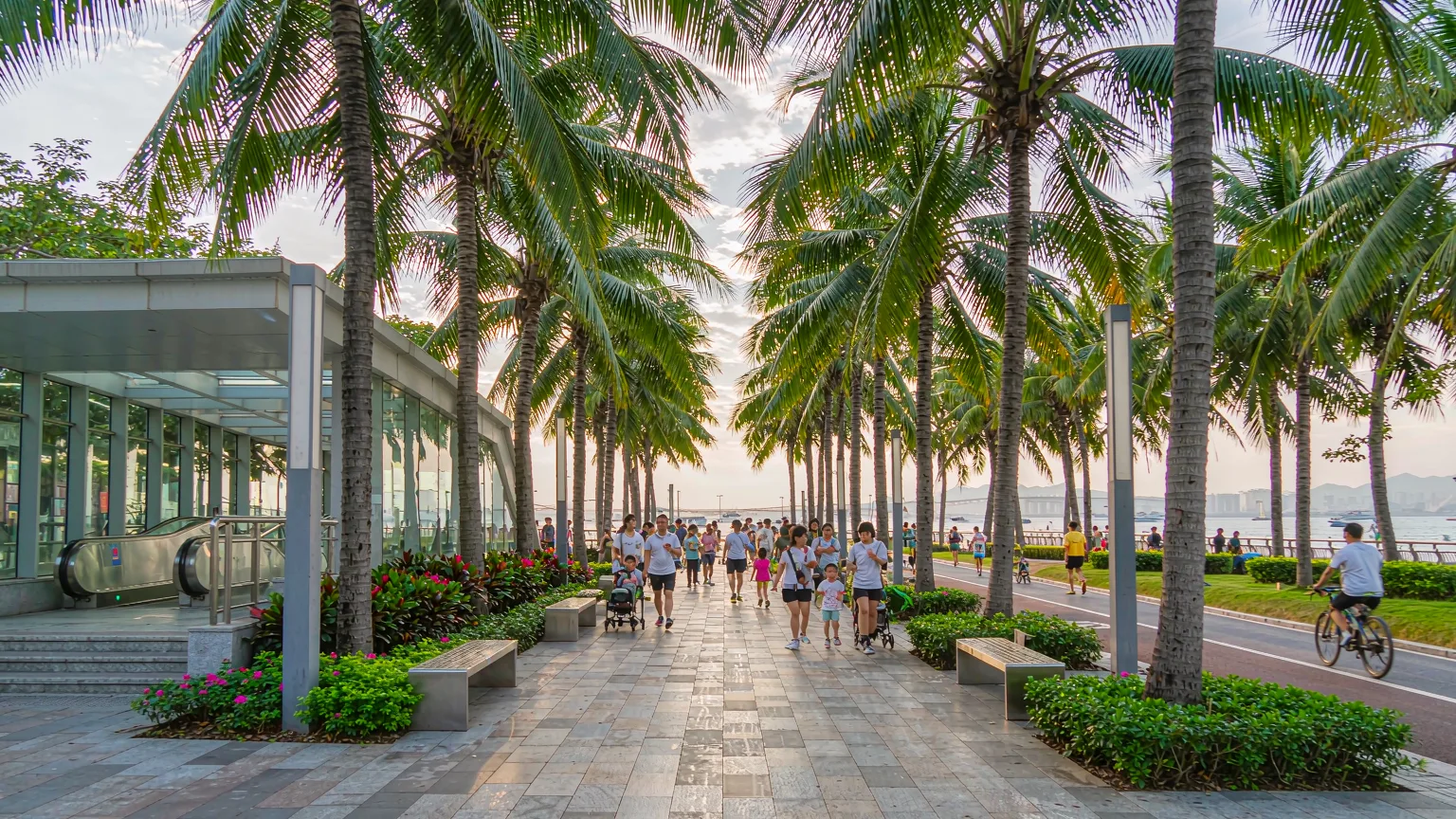 People walking and cycling into Shenzhen Bay Park from the metro entrance
