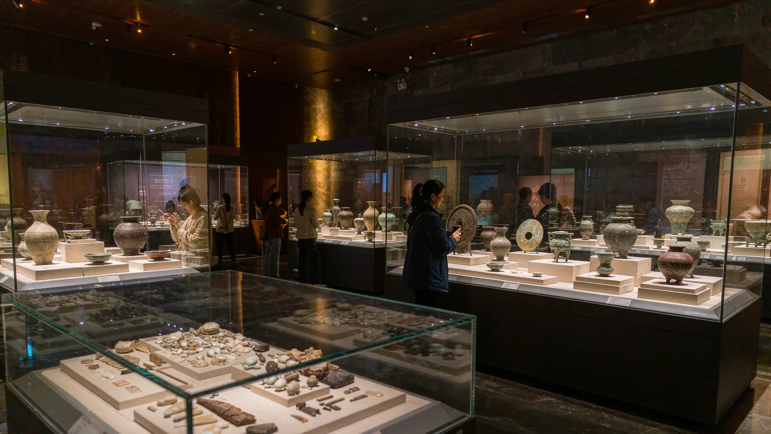 Ancient Shenzhen exhibition hall with artifacts in glass cases and visitors