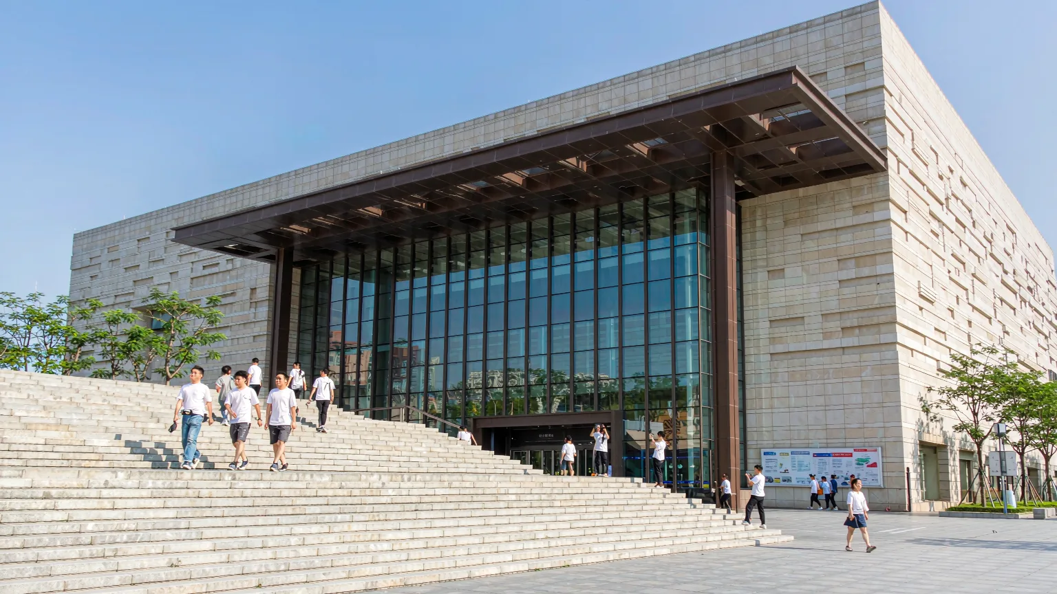 Visitors approaching the entrance of Shenzhen Museum on a sunny day