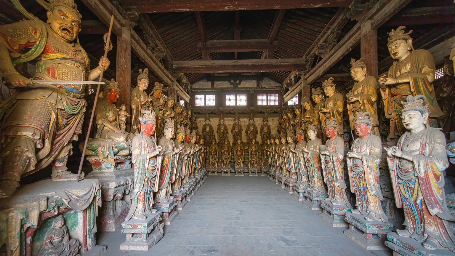 Interior of Shuanglin Temple hall with rows of painted clay sculptures
