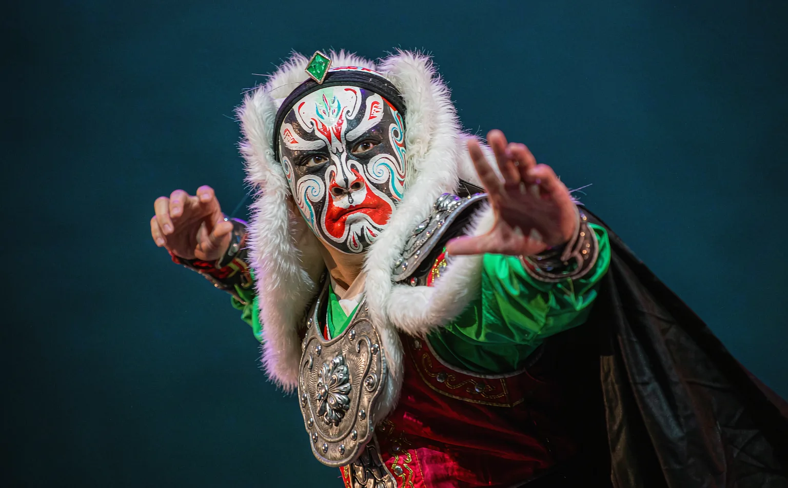 Close-up of a face-changing performer's painted mask