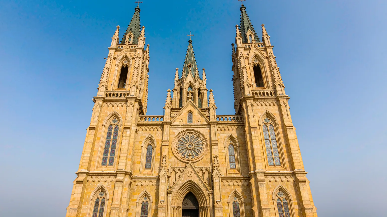 Front view of St. Michael's Cathedral with twin towers and rose window
