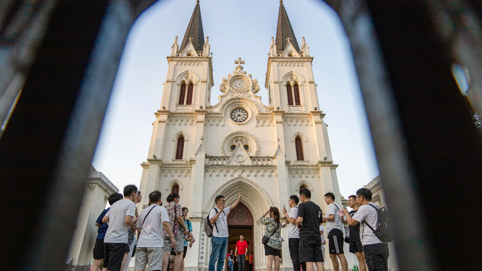 Tourists ascending steps to St. Michael's Cathedral entrance with guide