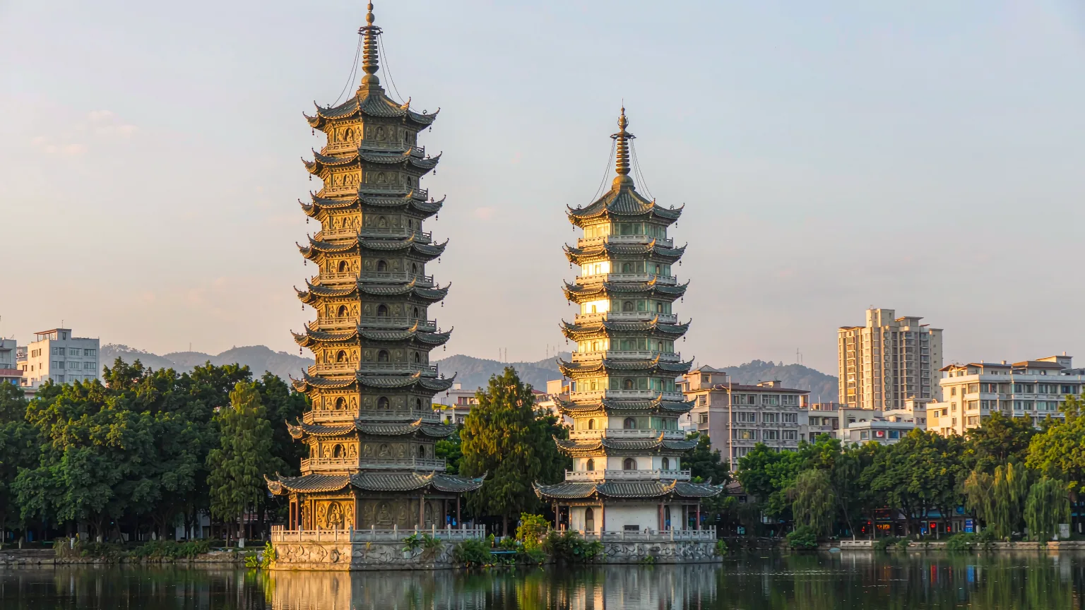 Bronze Sun Pagoda and glass Moon Pagoda side by side on Shan Lake