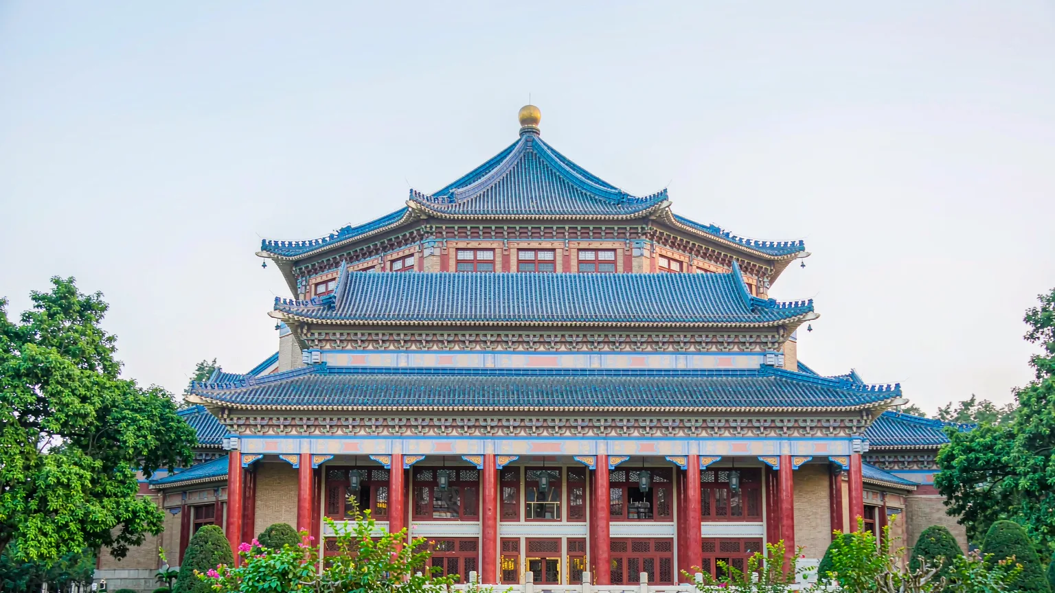 Front facade of Sun Yat-sen Memorial Hall with blue tiles and red columns