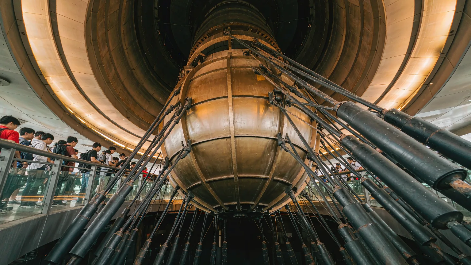 Golden tuned mass damper sphere inside Taipei 101's upper floors