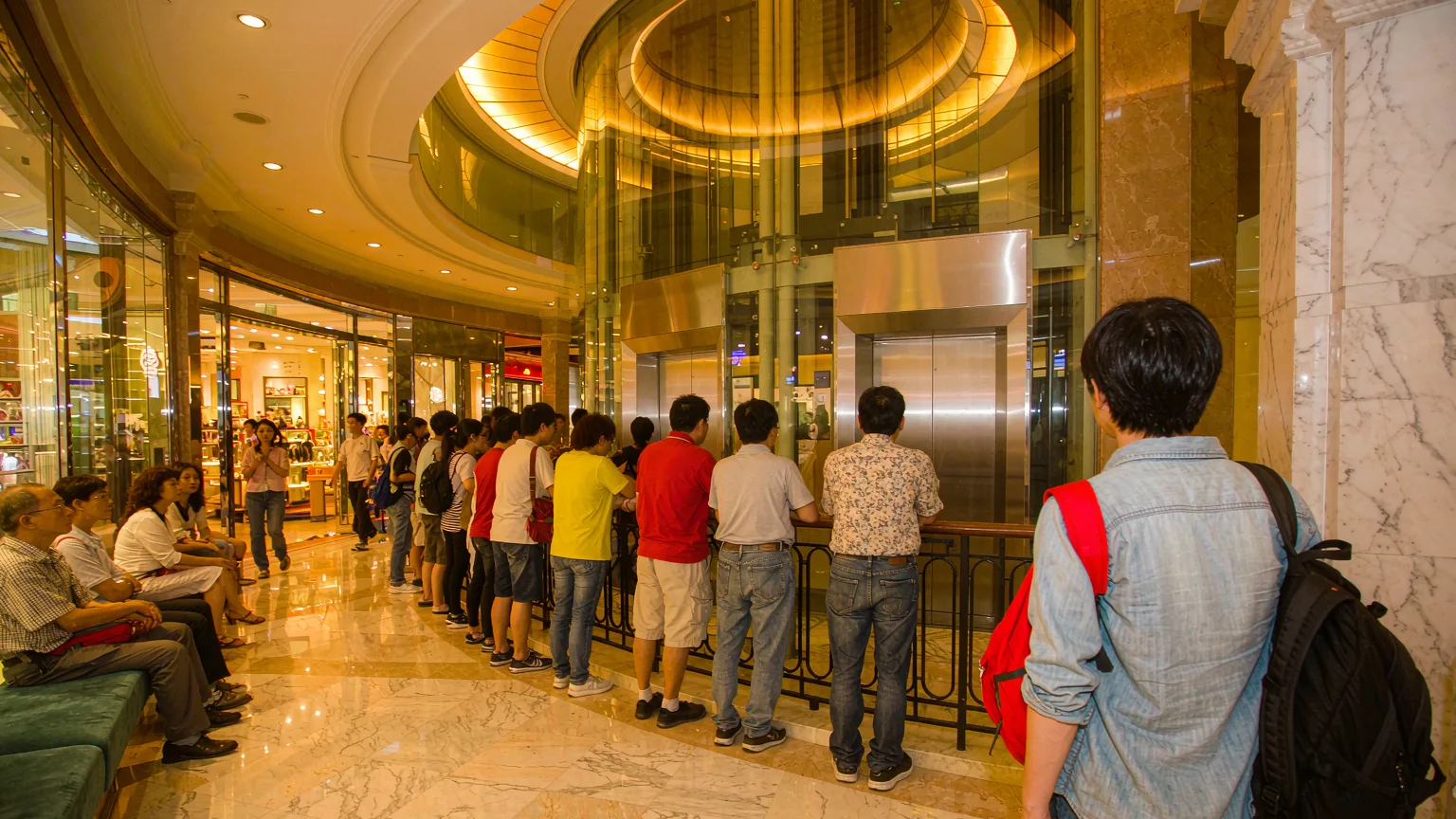 Tourists heading to the Taipei 101 observatory elevator through the mall lobby