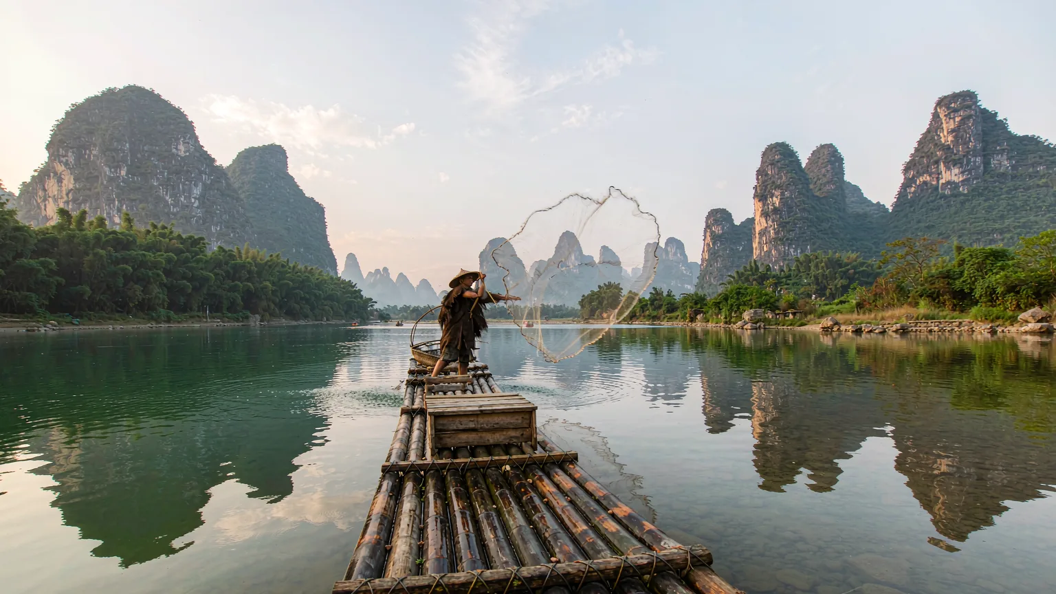 Bamboo raft on Yulong River with karst reflection near Ten-Mile Gallery