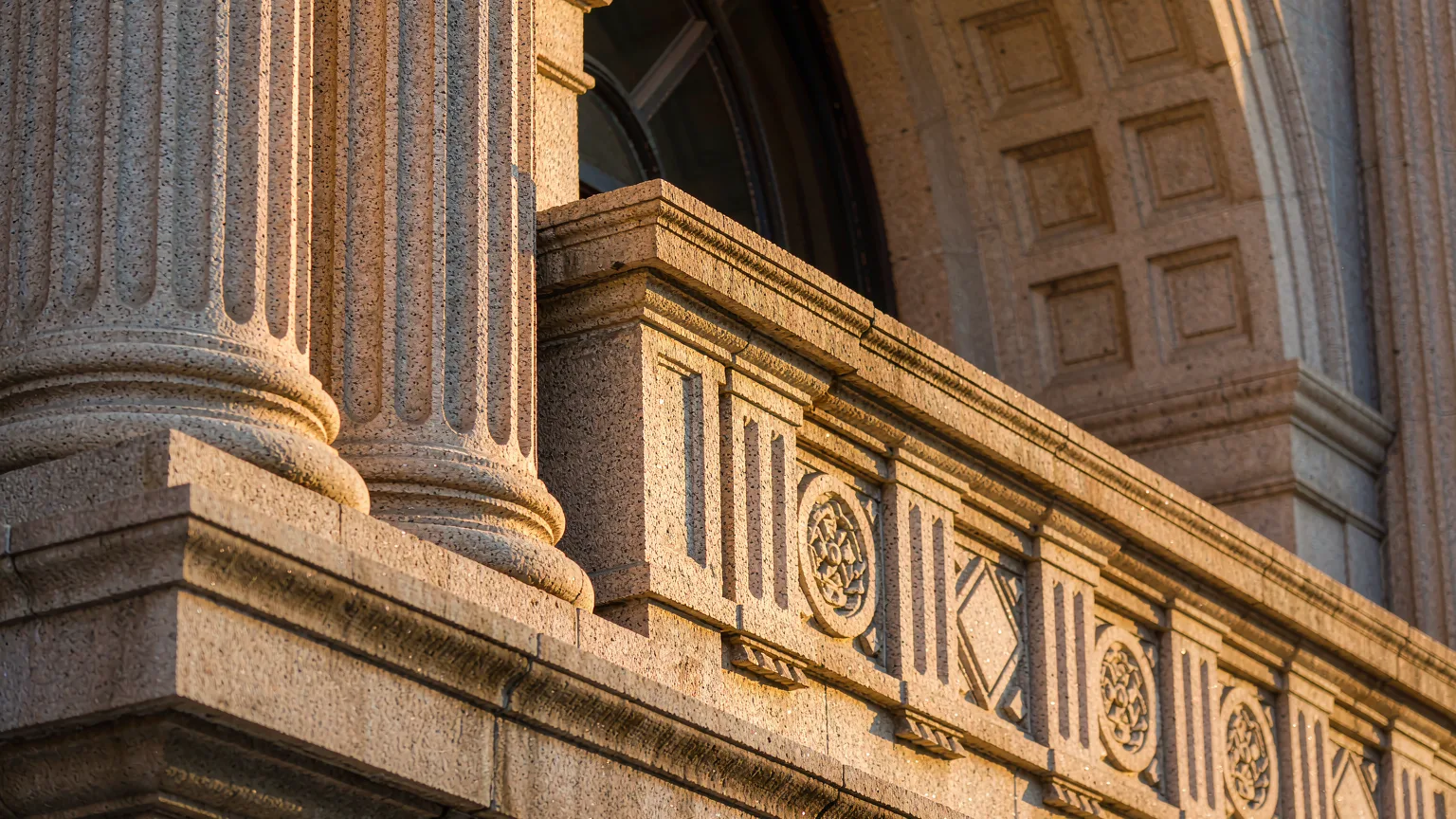 Close-up of ornate stone carvings on a Bund building facade