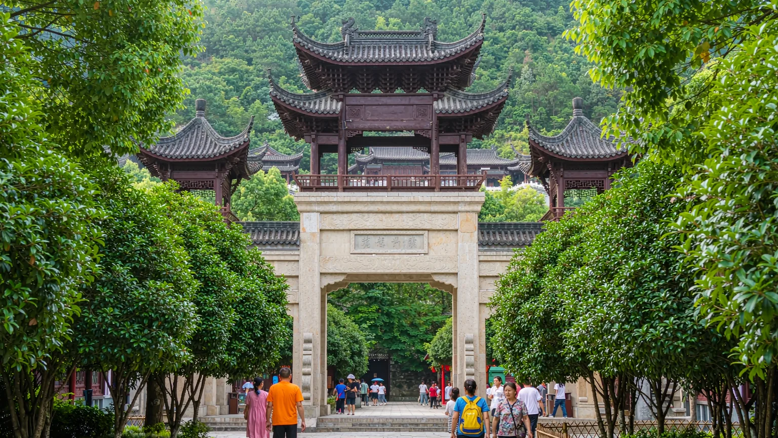 Tourists walking on stone path at Tianhetan Scenic Area entrance