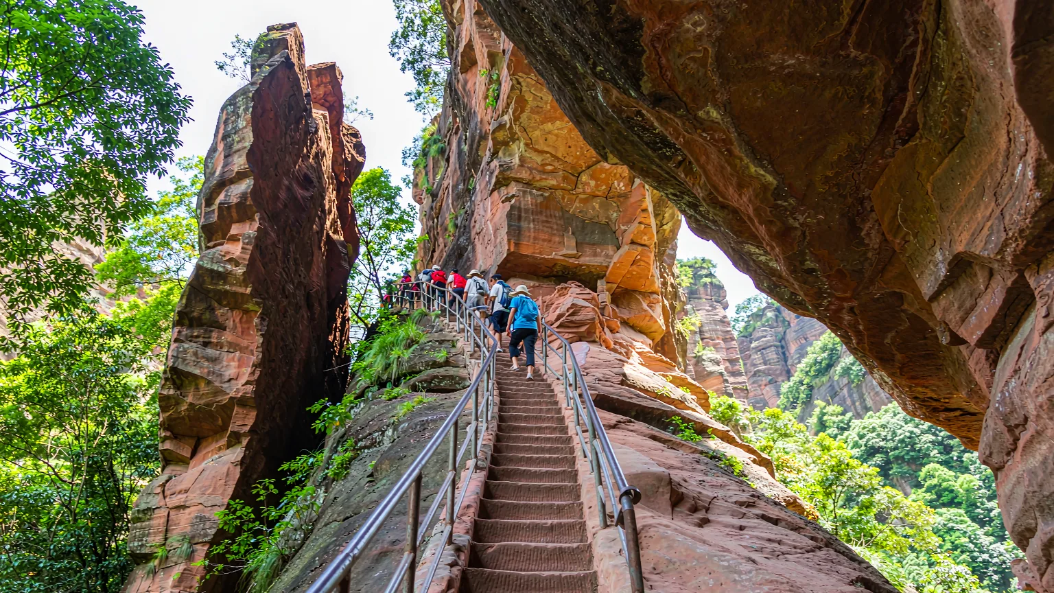 Steep stone stairway ascending the red sandstone cliff of Tianyou Peak