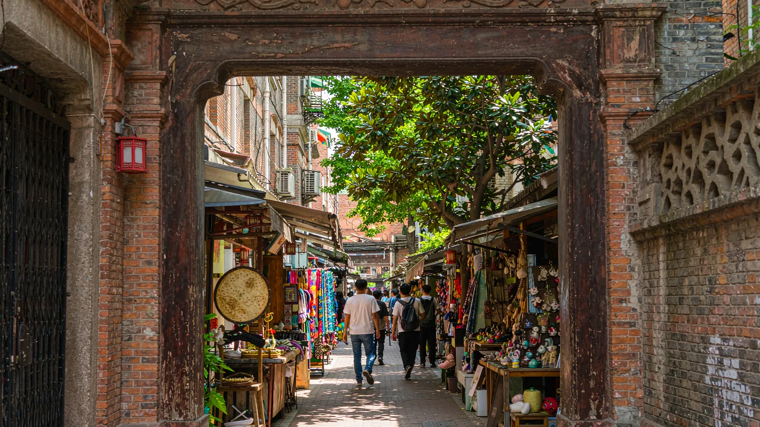 Visitor entering Tianzifang through a shikumen archway from Taikang Road